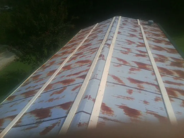 Rusted metal roof panels with new wood purlins before replacement — Storm Damage Roof Repair in Fredericktown by Roofing Brothers