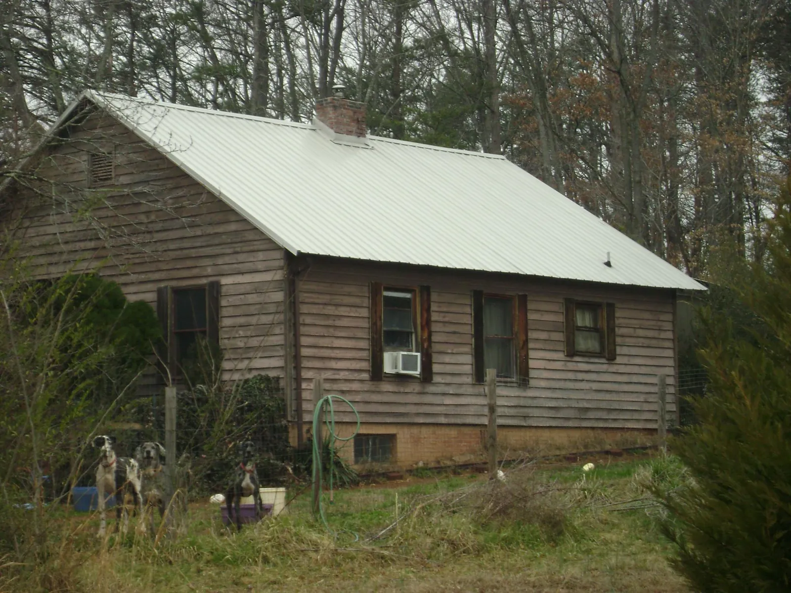 White metal roof on an old wood sided farmhouse, from a Metal Roof Installation job in Fredericktown
